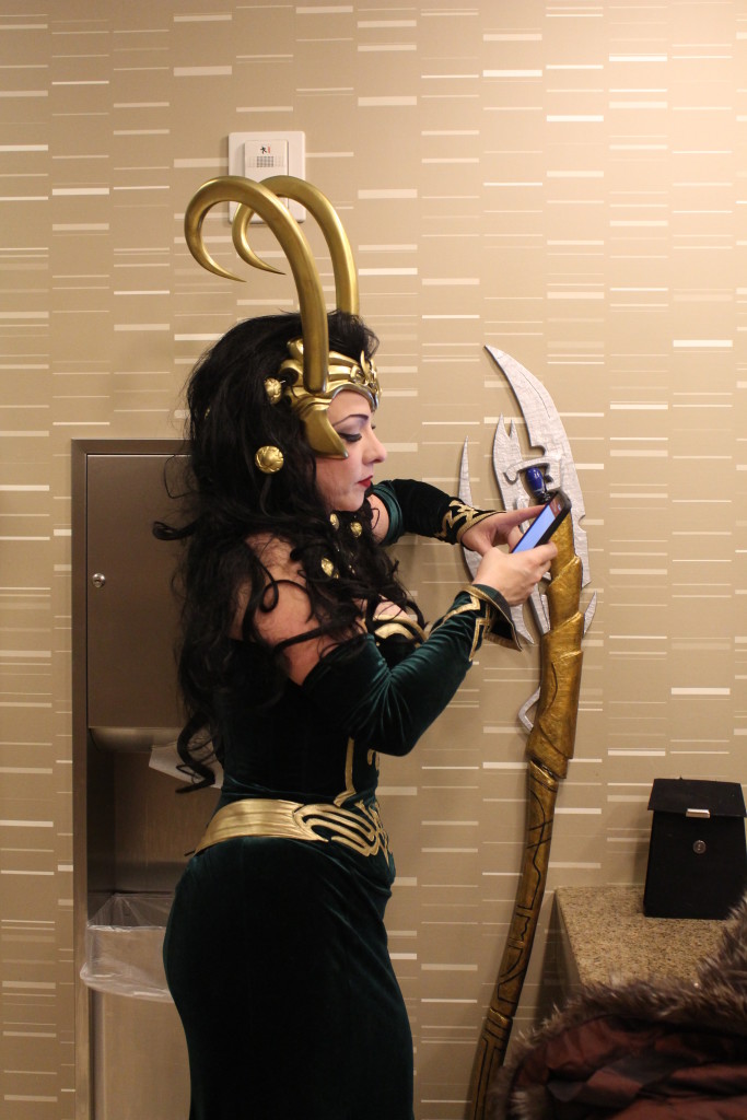 Here Cosplayer Blaze takes on the role of Lady Loki, and takes time out for a text, from Thor perhaps?