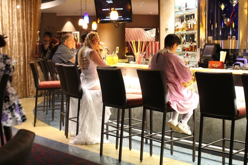 Thirteen from Stranger Things grabbing a beverage. She even had a waffle with her. This would be a really weird bar scene outside of DragonCon.