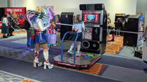 Cosplayers having fun in the arcade at AwesomeCon 2026.